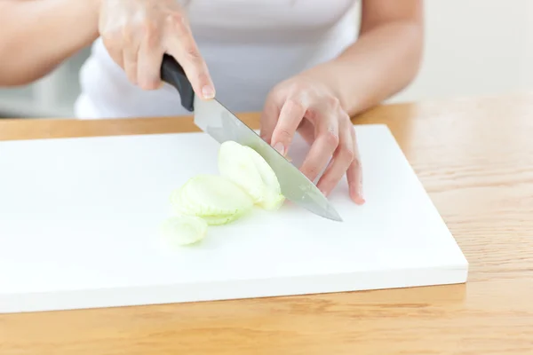 Delighted woman preparing onion in the kitchen — Stock Photo, Image
