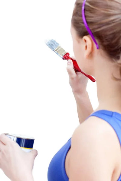 Young woman using a paintbrush — Stock Photo, Image