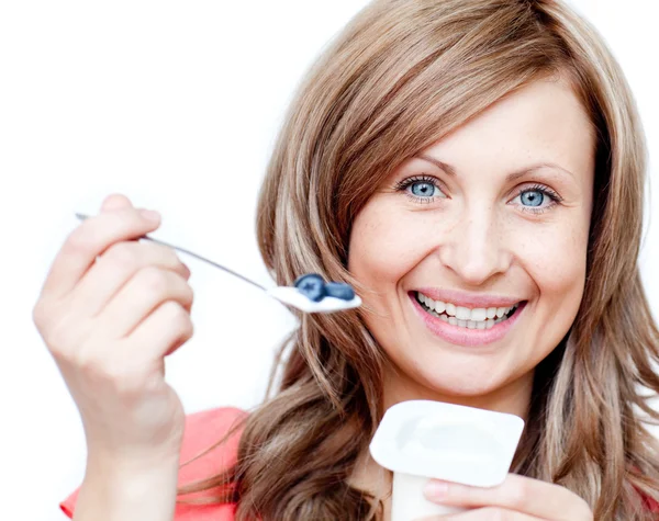 Mulher sorridente comendo um iogurte — Fotografia de Stock