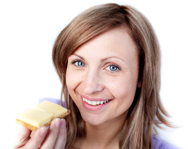 Beautiful woman eating a cracker with cheese — Stockfoto