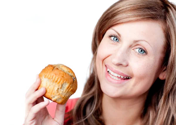 Smiling woman is eating a muffin — Stock Photo, Image