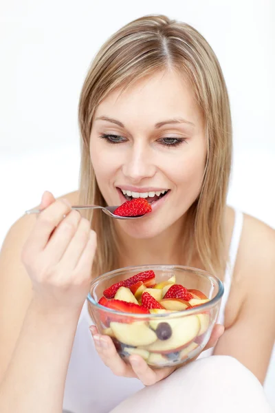 Charming woman eating fruit salad — Stock Photo, Image