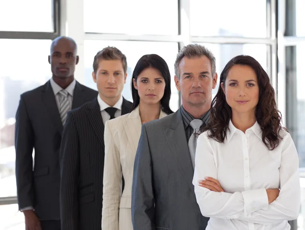 Business woman looking at camera with group in background — Stock Photo, Image