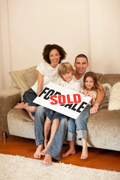 Happy family sitting on a sofa Stock Picture