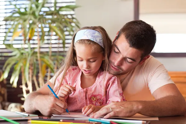 Happy father helping her daughter for homework Royalty Free Stock Images