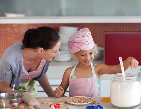 Lovely mother and her daughter baking in a kitchen Stock Photo