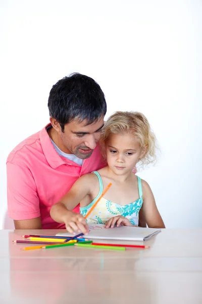 Radiant father drawing with his daughter Stock Photo