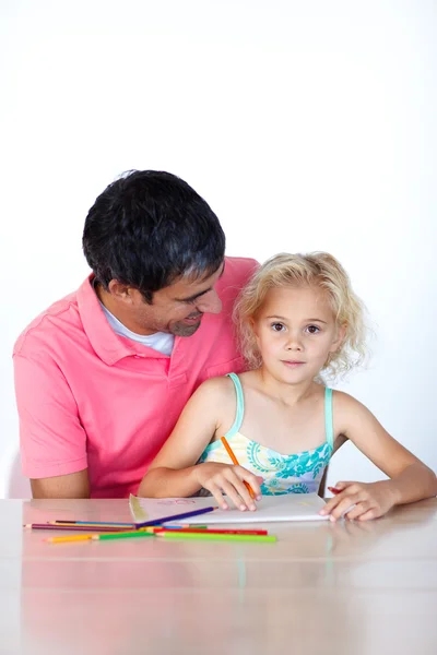 Cheerful father drawing with his daughter Royalty Free Stock Images