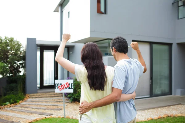 Happy couple after buying house Stock Picture