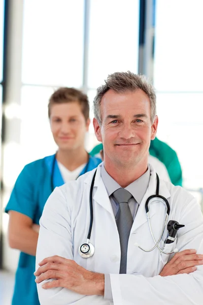 Mature doctor leading his team with copy-space Stock Image