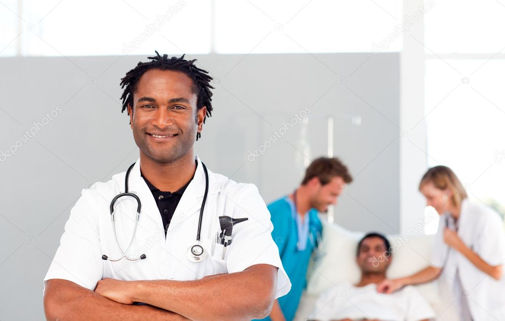 International Doctors Attending To A Patient Stock Photo By