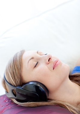 Close-up of a relaxed woman listening music clipart