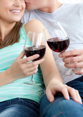 Close-up of a young couple drinking red wine clipart