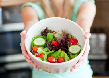 Young woman showing a salad clipart