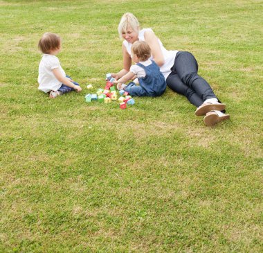 Smiling mother having fun with her kids clipart