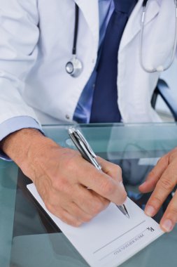 Portrait of a doctor writing a prescription clipart