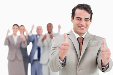 Salesman with team behind him giving thumbs up clipart