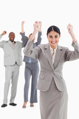 Triumphant saleswoman with cheering associates behind her clipart