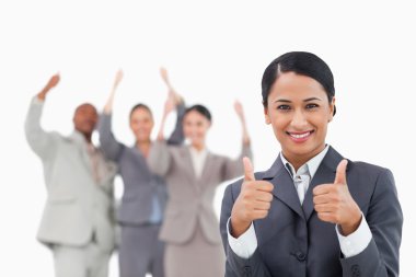 Saleswoman with cheering team behind her giving approval clipart