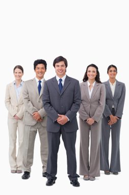 Smiling businessman standing with his team clipart