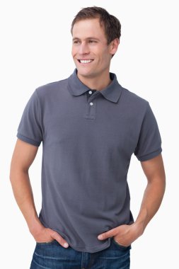 Smiling male with hands in his pockets clipart