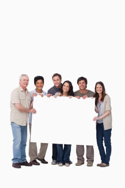 Smiling group of friends holding blank sign together clipart