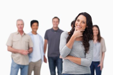 Smiling woman in thinkers pose and friends behind her clipart