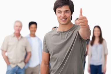 Smiling man with friends behind him giving approval clipart