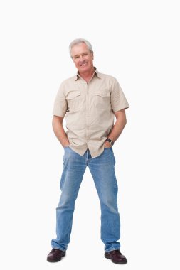 Mature male with hands in his pockets clipart