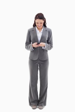 Businesswoman writing a text message clipart