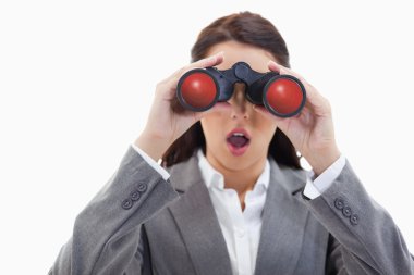 Close-up of a surprised businesswoman looking through binoculars clipart