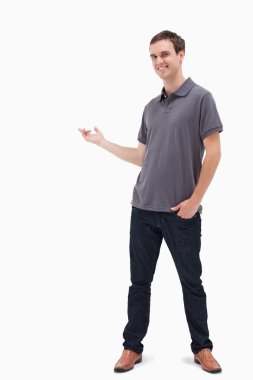 Happy man standing and presenting something behind clipart