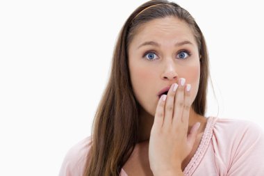 Shocked girl with her hand over her mouth clipart