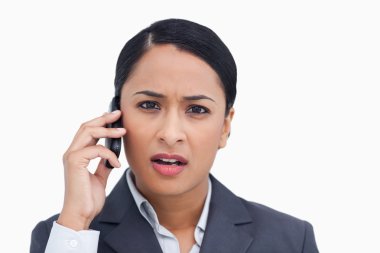 Close up of saleswoman getting bad news from caller clipart