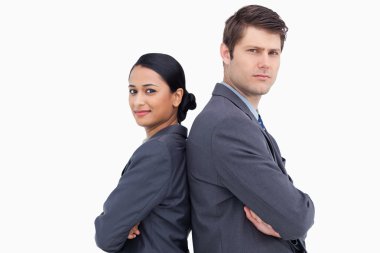 Close up of serious salesteam standing back to back clipart