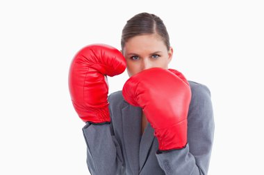Tradeswoman with boxing gloves in defensive position clipart