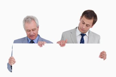 Tradesmen looking at blank sign in their hands clipart