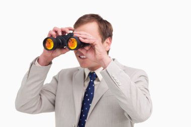 Businessman using spy glasses clipart