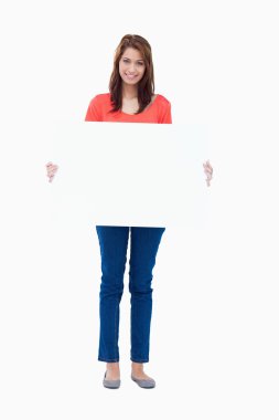 Teenager holding a blank poster against a white background clipart