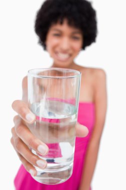 Glass of pure water held by an attractive teenage girl clipart