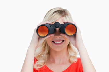 Blonde woman looking through binoculars clipart