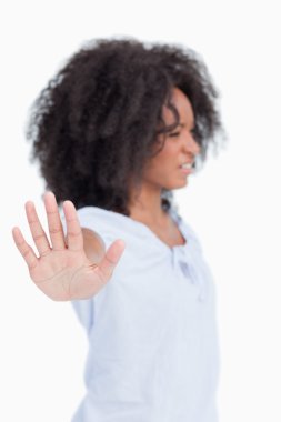 Side view of a woman being angry and making the hand stop sign clipart