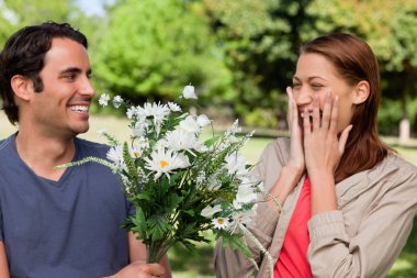 Young woman holding her hands against her face when presented wi clipart