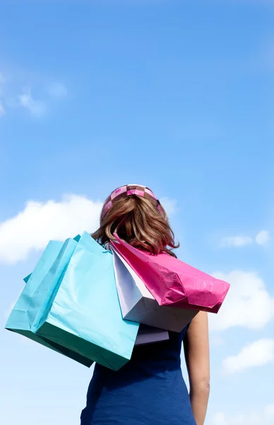 Smiling woman holding shopping bags outdoor — Stock Photo, Image