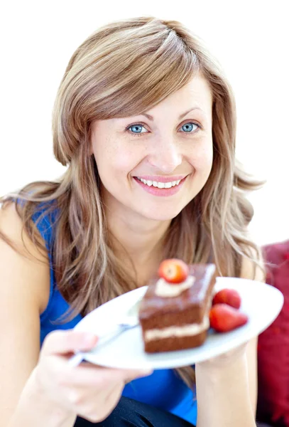 Smiling woman holding a piece of chocolate cake — Stock Photo, Image