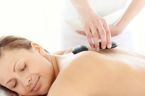 Portrait of a radiant woman having a massage with stones — Stock Photo, Image
