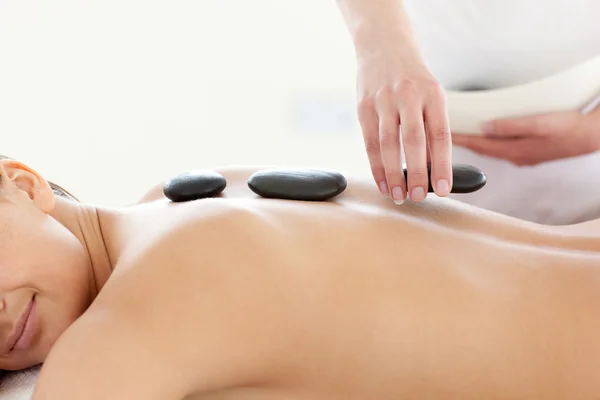 Portrait of a beautiful woman having a massage with stones — Stock Photo, Image