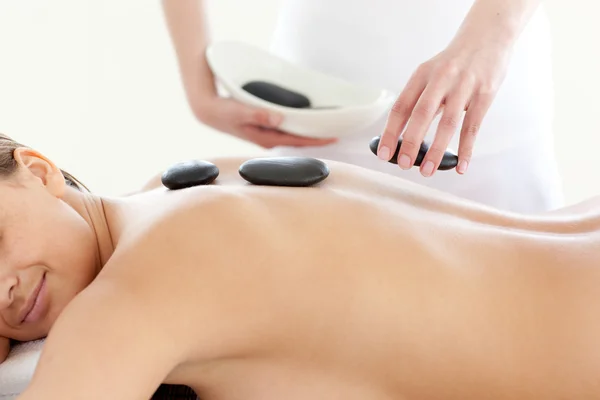 Portrait of a cute woman having a massage with stones — Stock Photo, Image