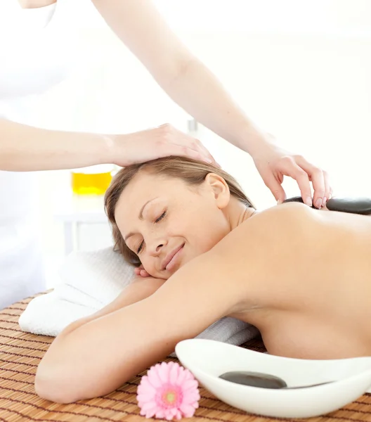 Portrait of a cheerful woman having a massage with stones — Stock Photo, Image
