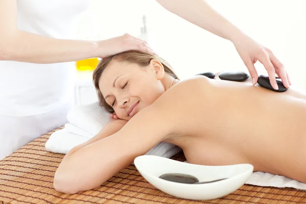Portrait of a positive woman having a massage with stones — Stock Photo, Image